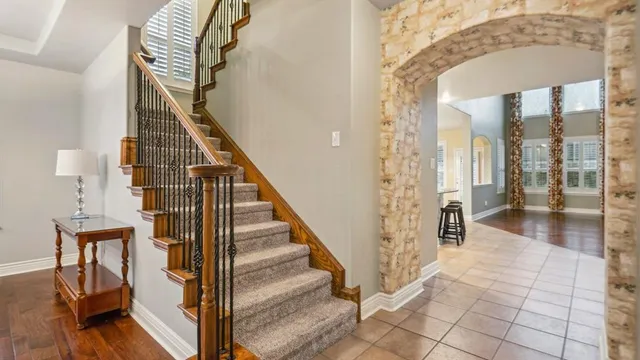 a view of an entryway with wooden floor and staircase