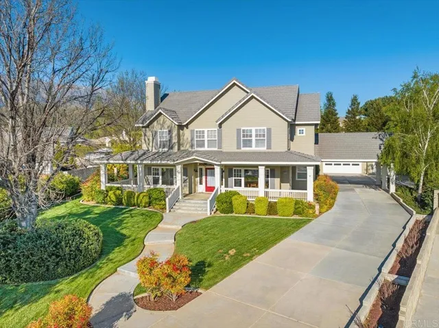 a front view of a house with a yard table and chairs