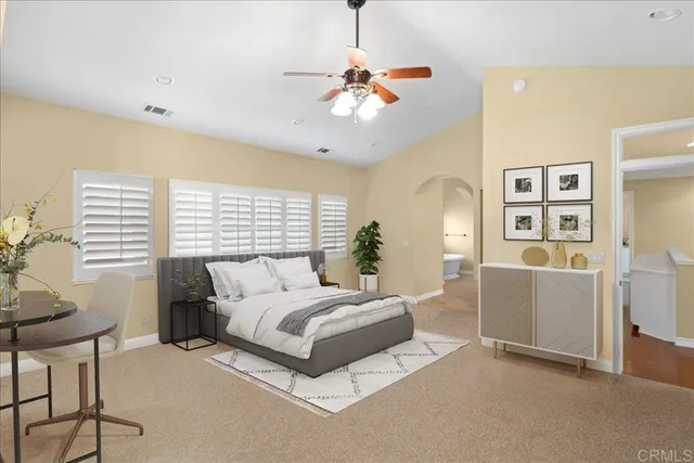 a spacious bedroom with a bed and a window