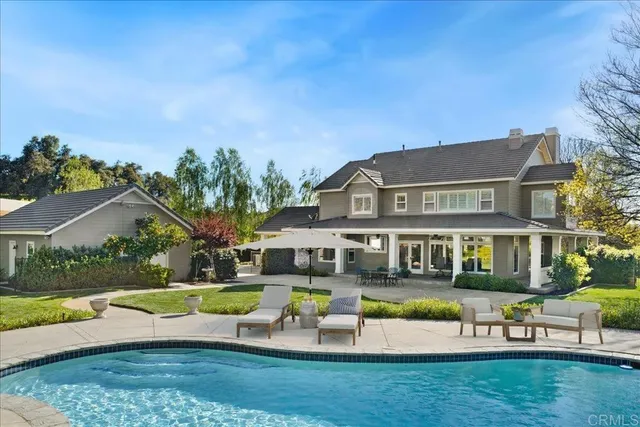 a view of an house with swimming pool yard and outdoor seating