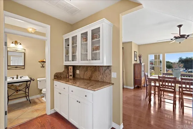 a kitchen with a table chairs and wooden floor