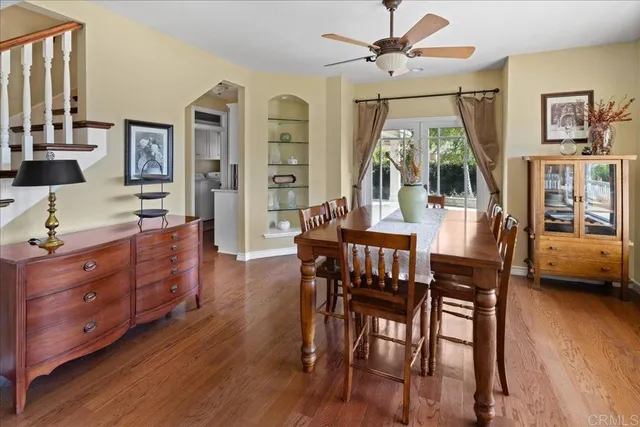a dining room with furniture a chandelier and wooden floor