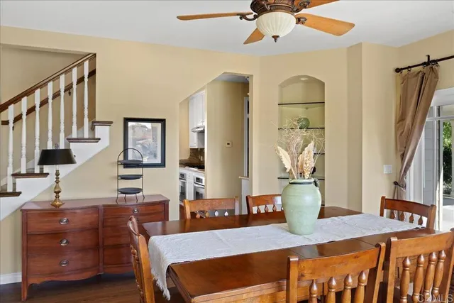a view of a a dining room with furniture window and wooden floor