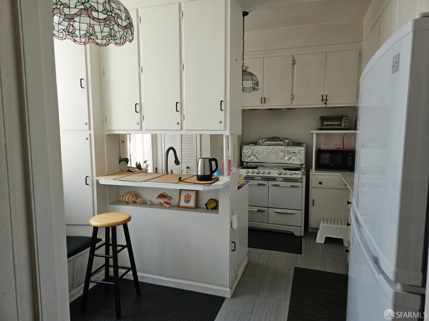 841-845 Fulton Street San Francisco, CA 94117 - Photo 17 of 32 a kitchen with stainless steel appliances granite countertop a stove and a refrigerator