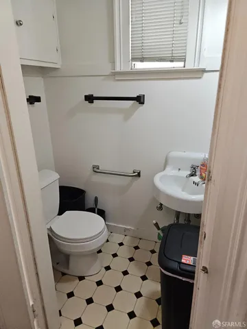 a bathroom with a sink toilet and a mirror