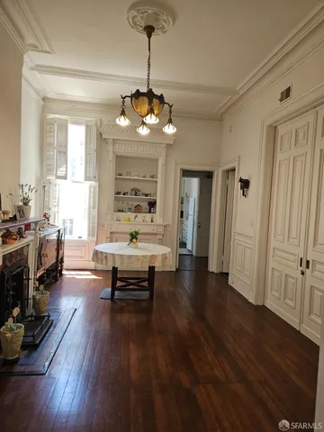 a view of a livingroom with furniture wooden floor and a window