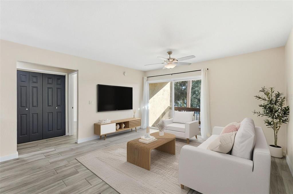 3405 Clark Road, Unit 205 Sarasota, FL 34231 - Photo 13 of 38 a living room with furniture and a flat screen tv