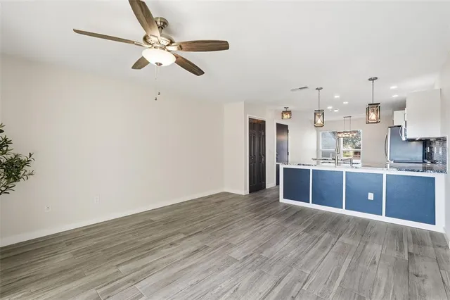 a view of kitchen with wooden floor electronic appliances and window