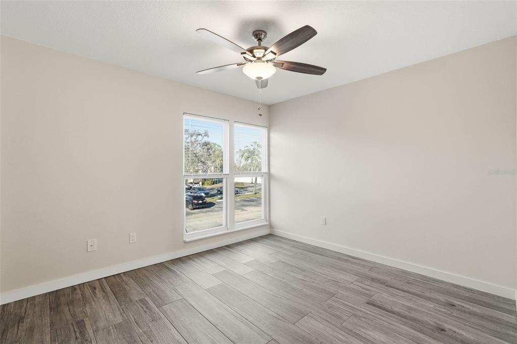 3405 Clark Road, Unit 205 Sarasota, FL 34231 - Photo 25 of 38 wooden floor in an empty room with a window