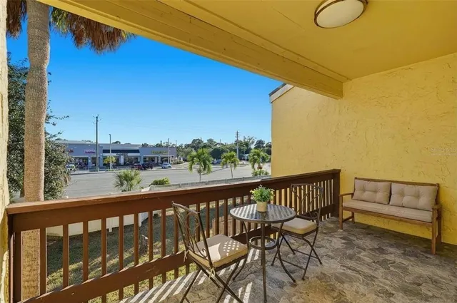 a view of a balcony with chairs