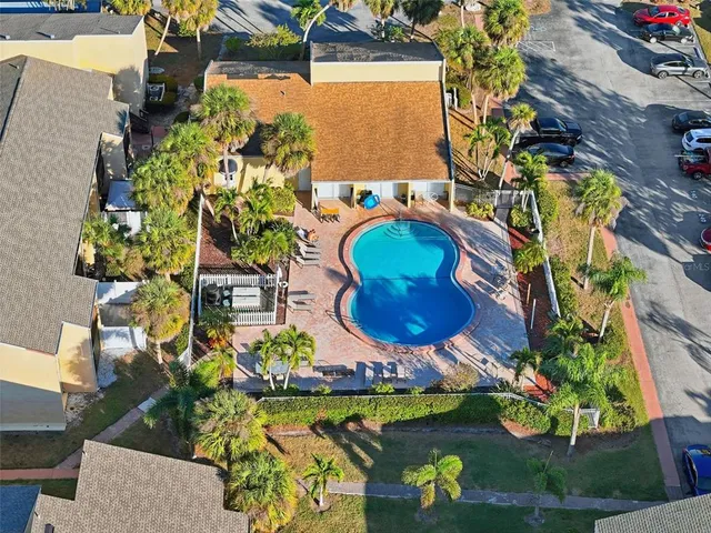 an aerial view of a house with a swimming pool yard and outdoor seating