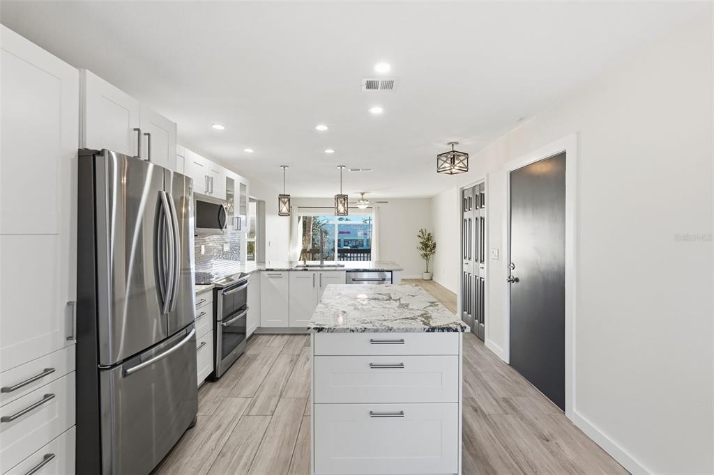 3405 Clark Road, Unit 205 Sarasota, FL 34231 - Photo 6 of 38 a kitchen with refrigerator and cabinets