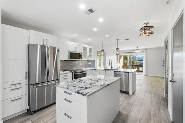 a kitchen with refrigerator a stove and a refrigerator