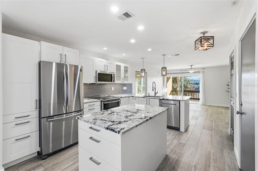 3405 Clark Road, Unit 205 Sarasota, FL 34231 - Photo 7 of 38 a kitchen with refrigerator a stove and a refrigerator