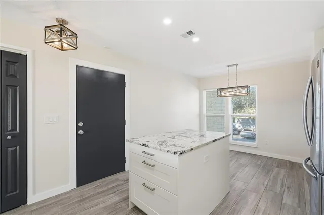 a hallway with cabinets and wooden floor