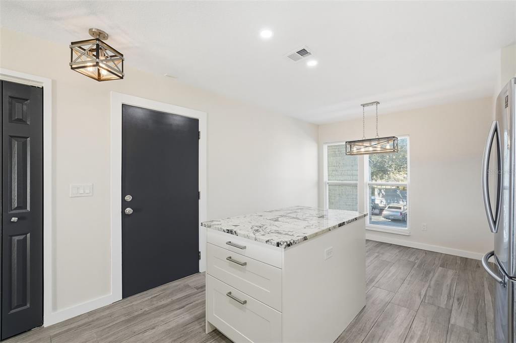 3405 Clark Road, Unit 205 Sarasota, FL 34231 - Photo 8 of 38 a hallway with cabinets and wooden floor