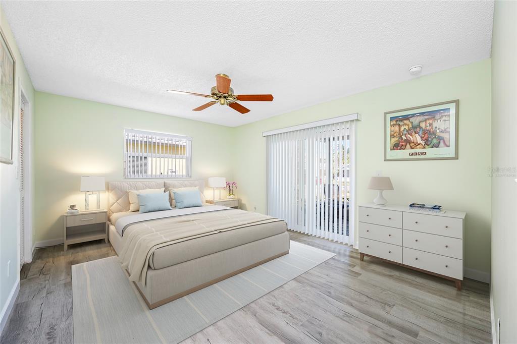 119 13th Avenue Indian Rocks Beach, FL 33785 - Photo 15 of 32 a bedroom with a bed and a chandelier
