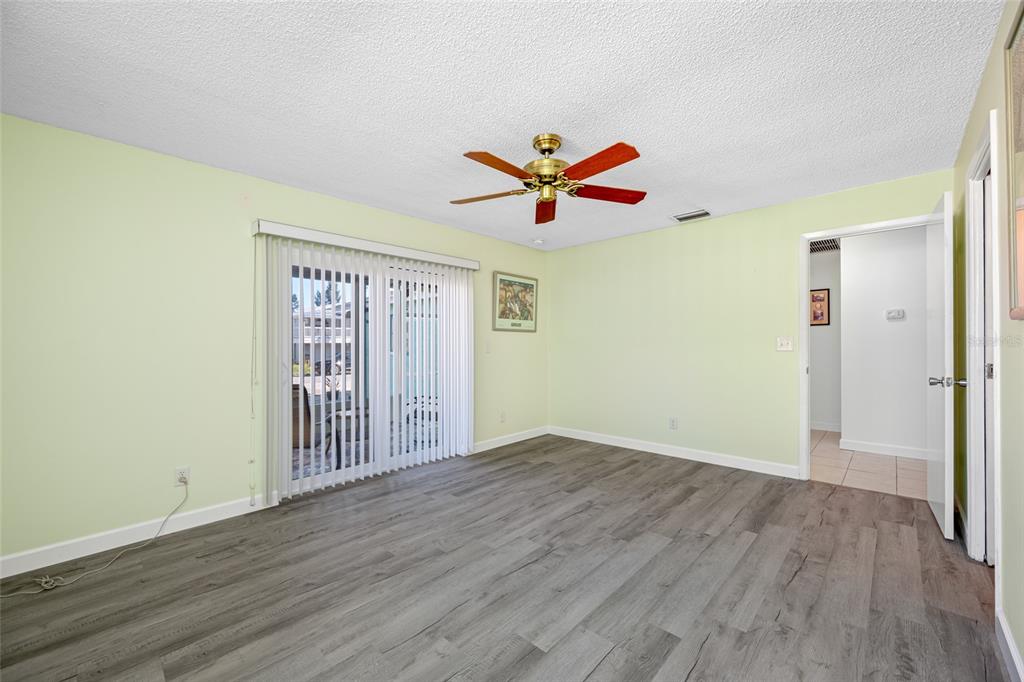119 13th Avenue Indian Rocks Beach, FL 33785 - Photo 17 of 32 an empty room with wooden floor and window