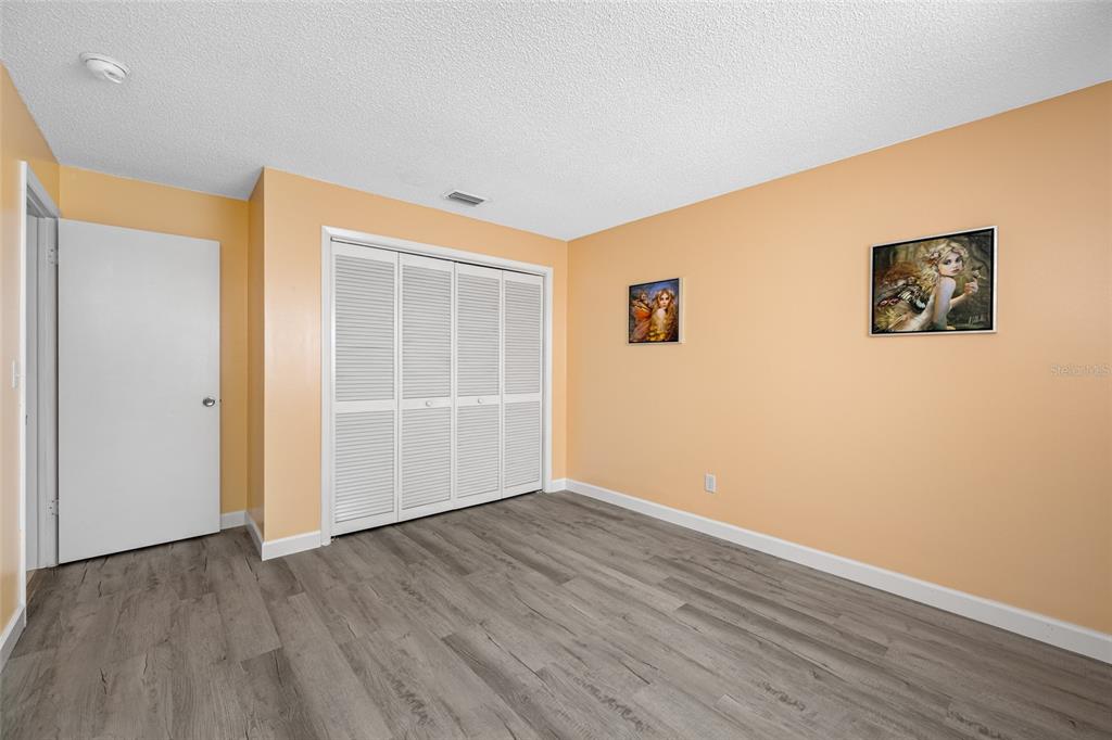 119 13th Avenue Indian Rocks Beach, FL 33785 - Photo 22 of 32 a view of an empty room with wooden floor and a window