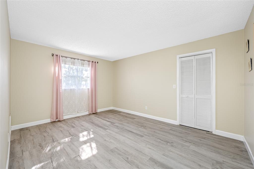 119 13th Avenue Indian Rocks Beach, FL 33785 - Photo 26 of 32 an empty room with wooden floor and windows