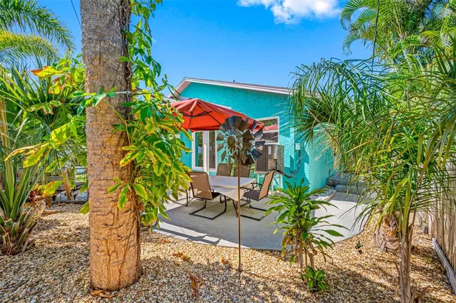 a dining room with furniture and a floor to ceiling window