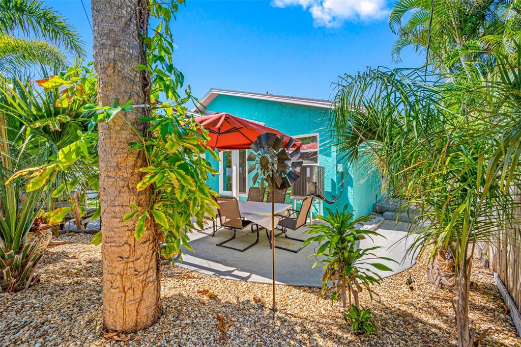 119 13th Avenue Indian Rocks Beach, FL 33785 - Photo 28 of 32 a view of a backyard with plants and a patio