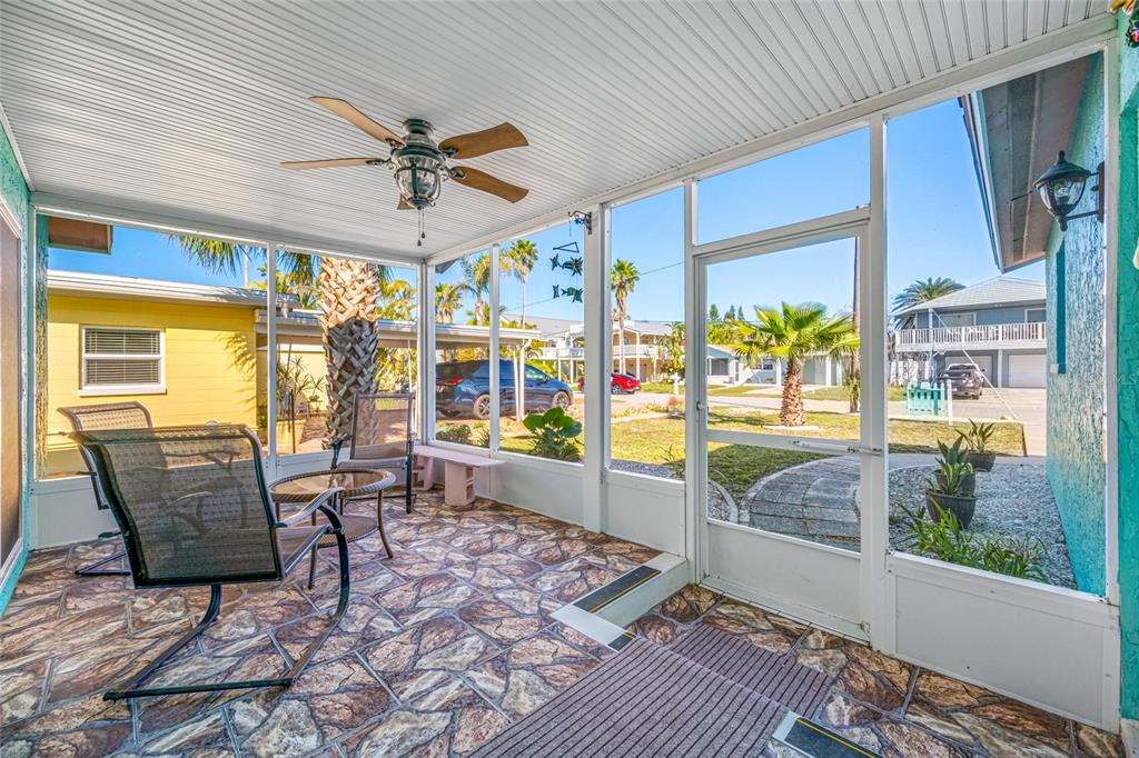 119 13th Avenue Indian Rocks Beach, FL 33785 - Photo 30 of 32 a dining room with furniture and a floor to ceiling window