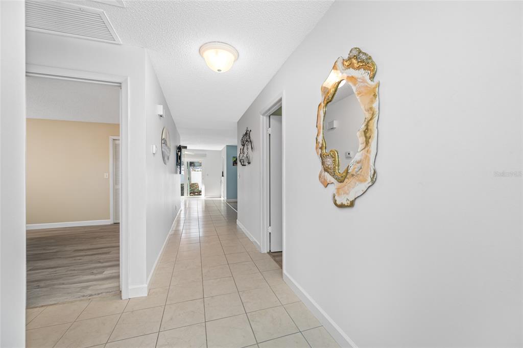 119 13th Avenue Indian Rocks Beach, FL 33785 - Photo 6 of 32 a view of a hallway view with wooden floor and entryway