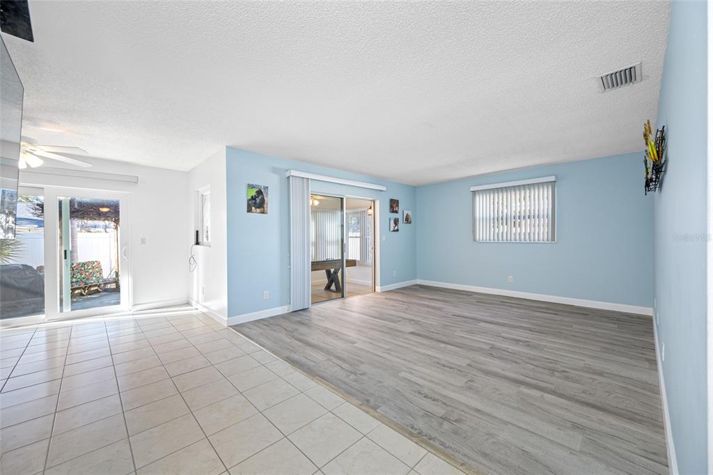 119 13th Avenue Indian Rocks Beach, FL 33785 - Photo 8 of 32 a view of an empty room with window and wooden floor