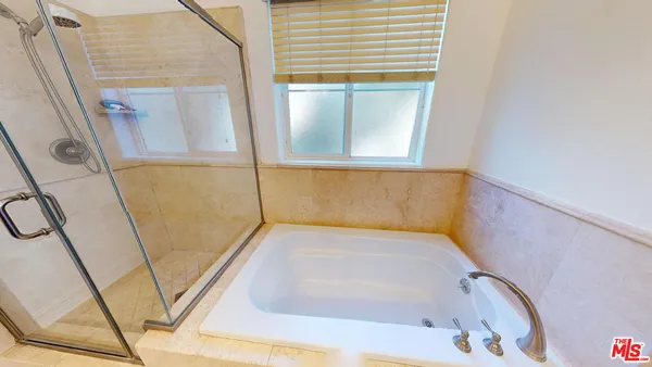 a bathroom with a tub and a window