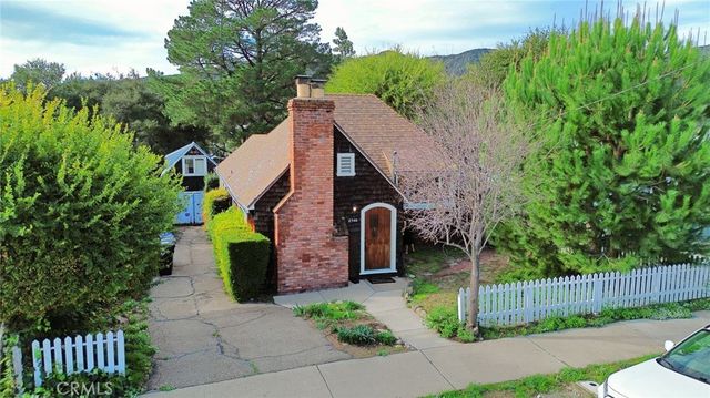 a aerial view of a house with a yard and plants