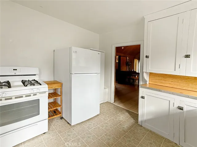 a kitchen with a stove and a refrigerator