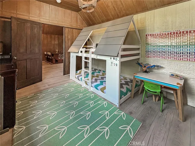 a room with a bed and a wooden floor