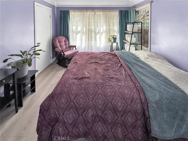 a bed sitting in a bedroom next to a window