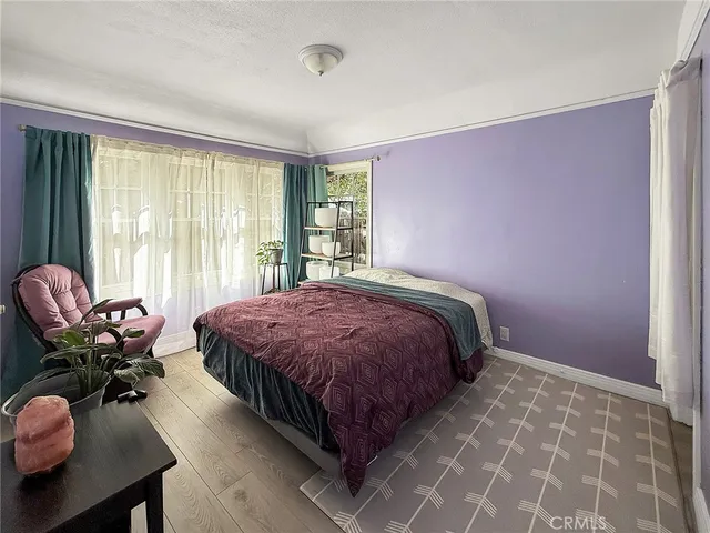 a view of a dining room with furniture large windows and wooden floor