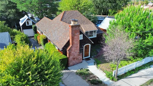 an aerial view of a house with a yard