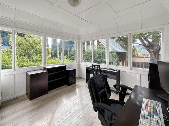 a view of a workspace with furniture and a window