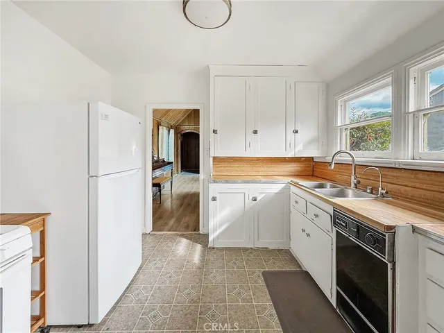 a kitchen with a sink stove and refrigerator