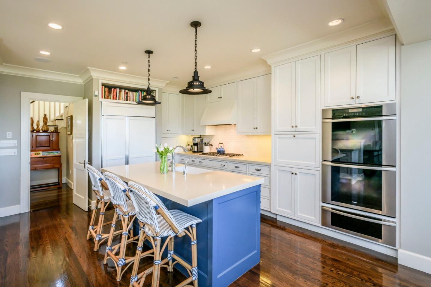 426 El Arroyo Road Hillsborough, CA 94010 - Photo 13 of 50 a kitchen with stainless steel appliances kitchen island granite countertop a refrigerator a sink and wooden floors
