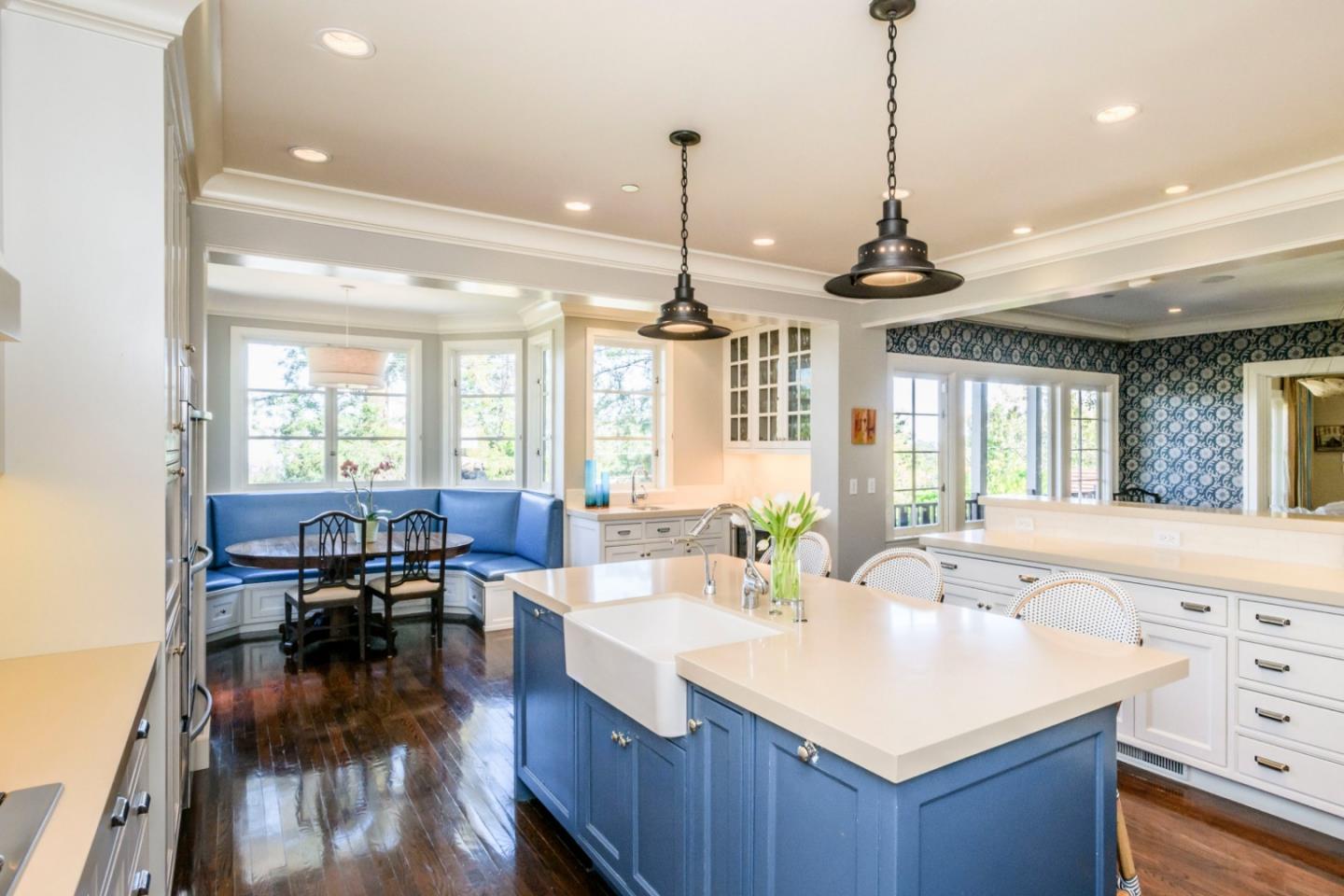 426 El Arroyo Road Hillsborough, CA 94010 - Photo 14 of 50 a view of a kitchen and dining room with wooden floor a chandelier