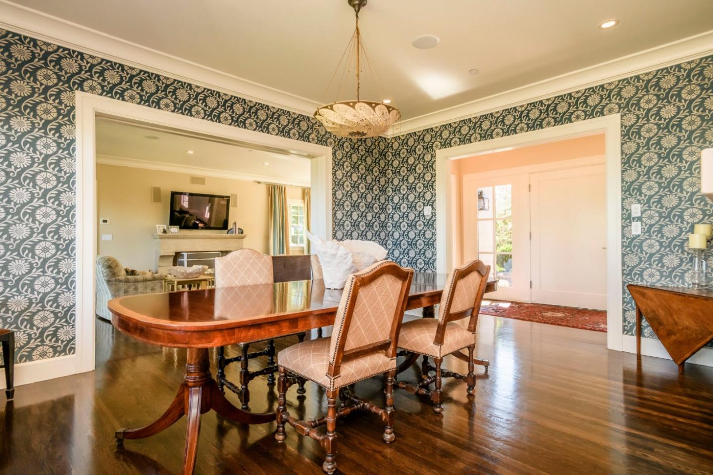 426 El Arroyo Road Hillsborough, CA 94010 - Photo 17 of 50 a dining room with furniture a chandelier and wooden floor