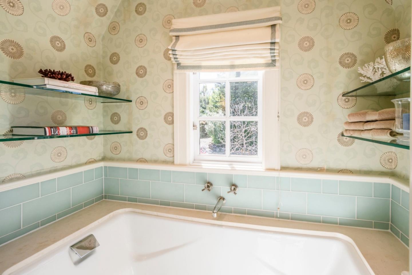 426 El Arroyo Road Hillsborough, CA 94010 - Photo 29 of 50 a bathroom with a bathtub and a shower