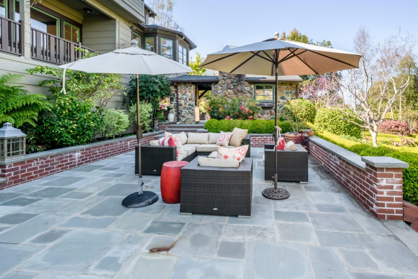 426 El Arroyo Road Hillsborough, CA 94010 - Photo 43 of 50 a view of a patio with chairs and a table under an umbrella