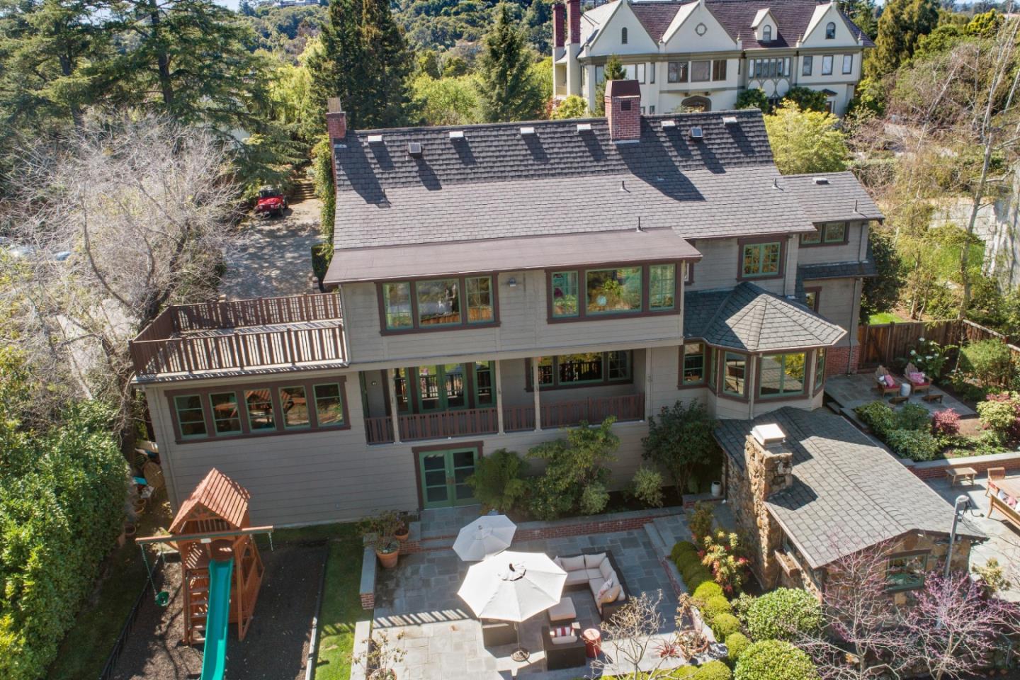426 El Arroyo Road Hillsborough, CA 94010 - Photo 45 of 50 aerial view of a house with table and chairs and a fire pit