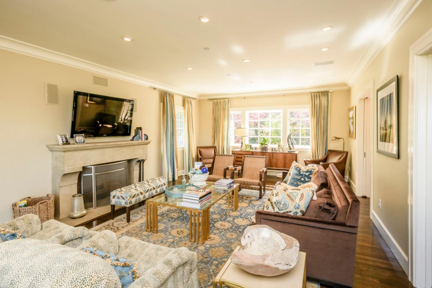 426 El Arroyo Road Hillsborough, CA 94010 - Photo 10 of 50 a living room with fireplace furniture and a flat screen tv