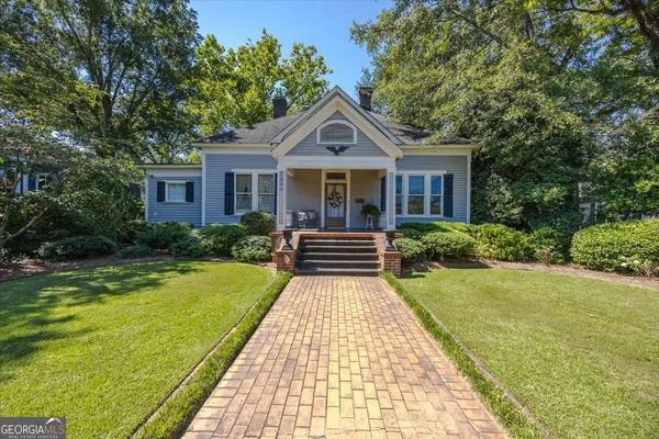 a front view of house with yard and green space