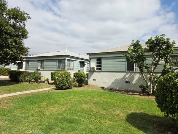 a view of house with backyard