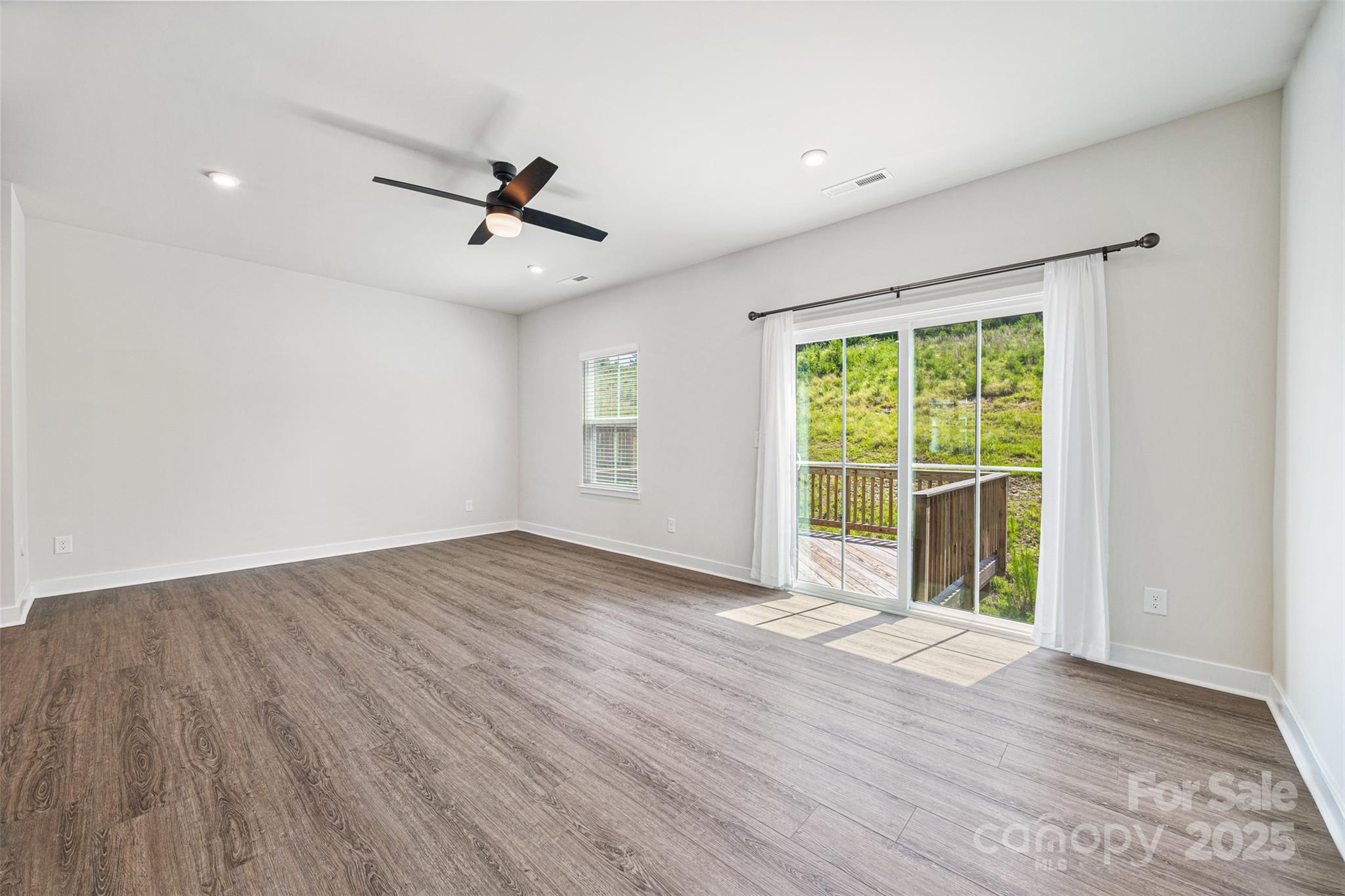 2040 Dornoch Road Tega Cay, SC 29708 - Photo 11 of 30 wooden floor in an empty room with a window