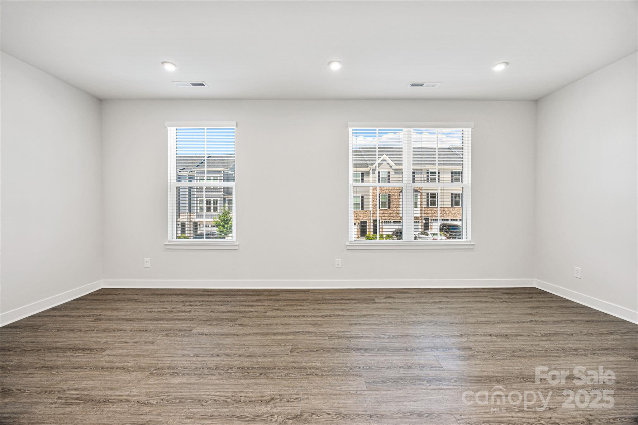 2040 Dornoch Road Tega Cay, SC 29708 - Photo 13 of 30 a view of an empty room with wooden floor and a window