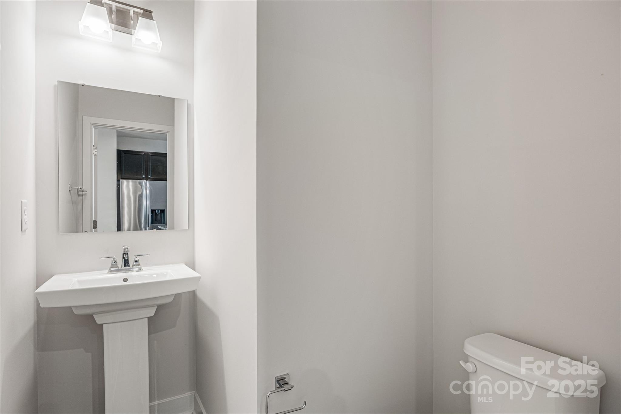 2040 Dornoch Road Tega Cay, SC 29708 - Photo 15 of 30 a bathroom with a sink a toilet and mirror